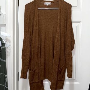 Rust orange cardigan with side details and pockets